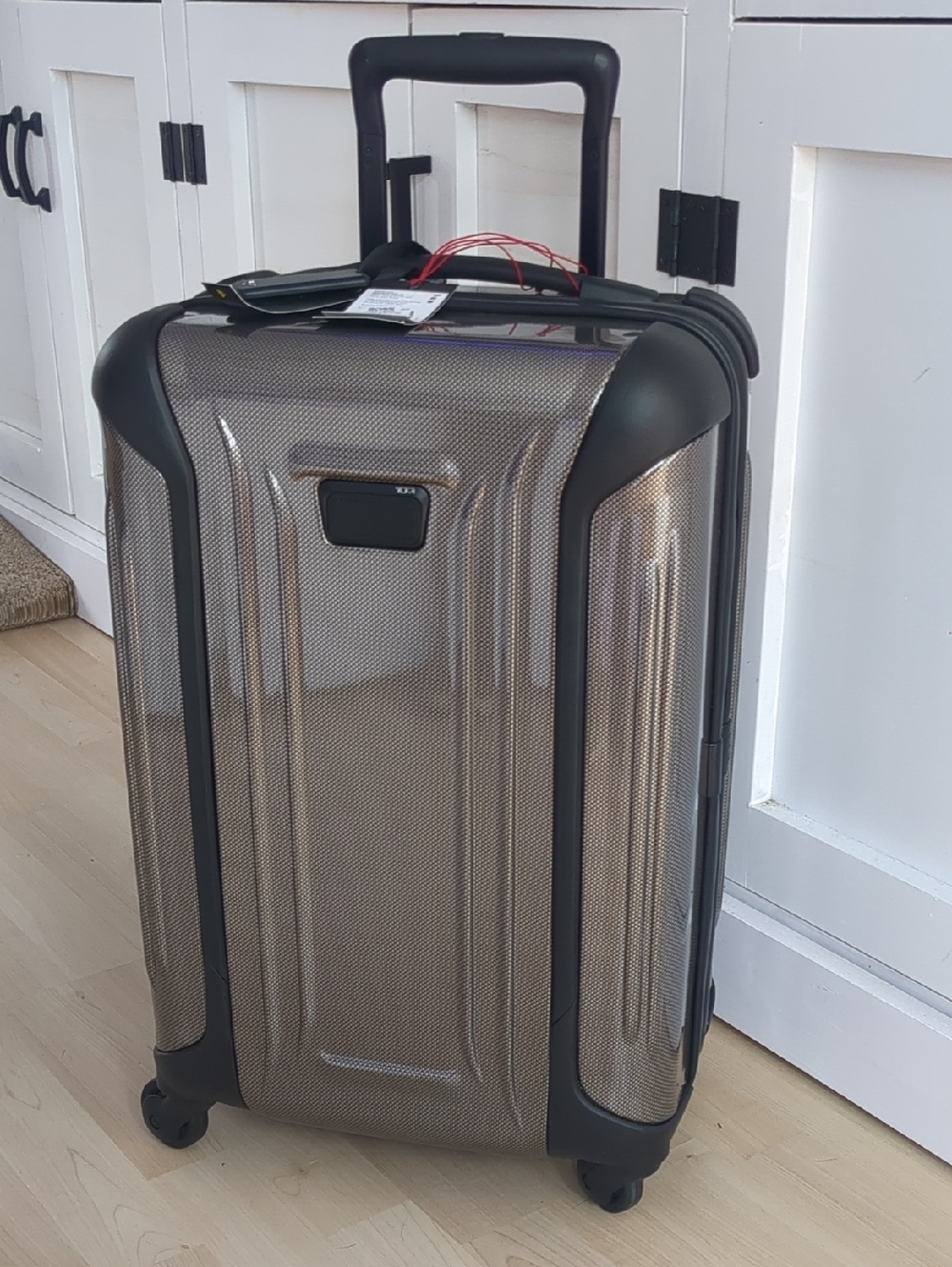 TUMI Hardshell Carry-On Roller in Metallic Tan-Beige.
